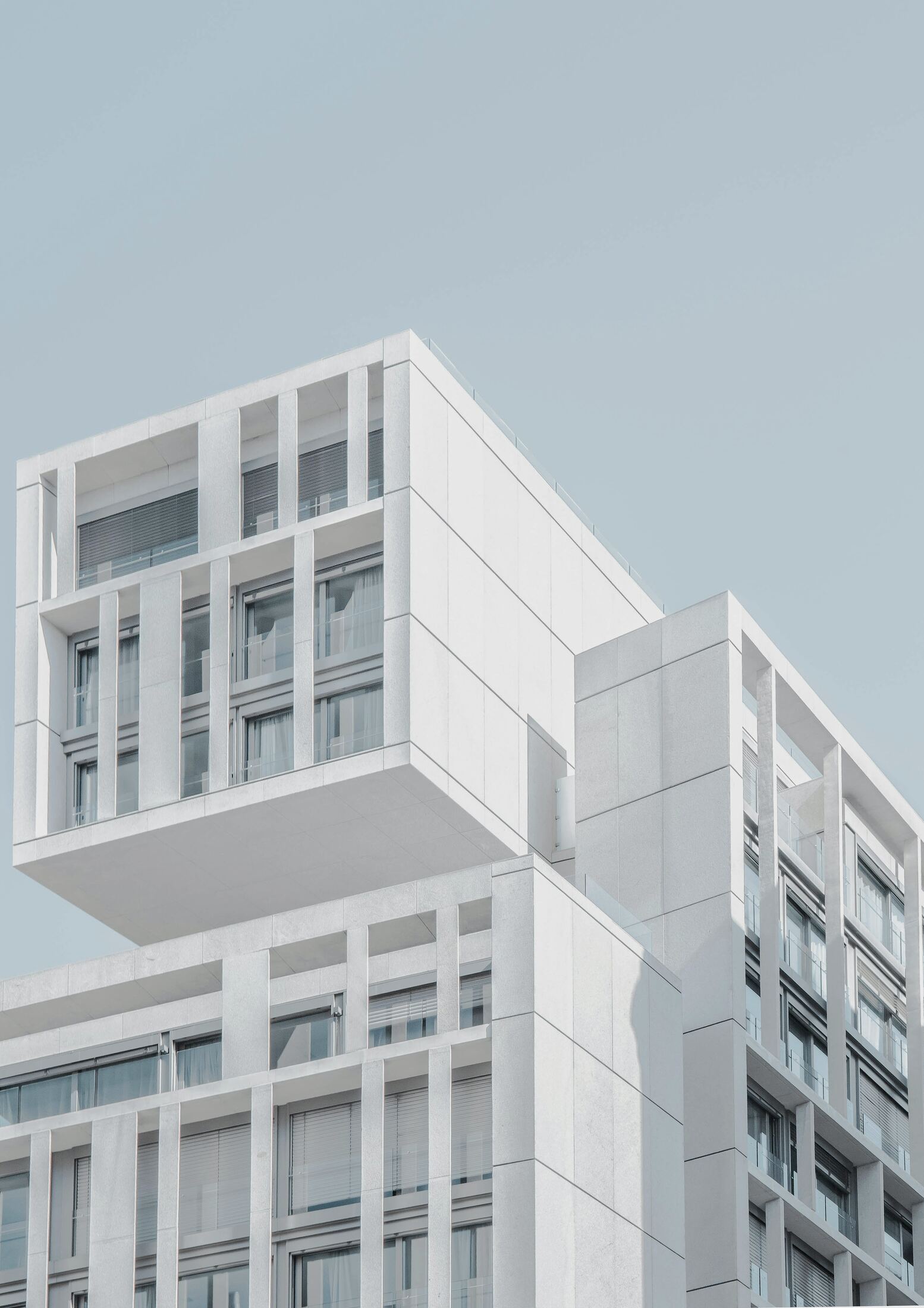 Modern residential building corner with cantilevered volumes