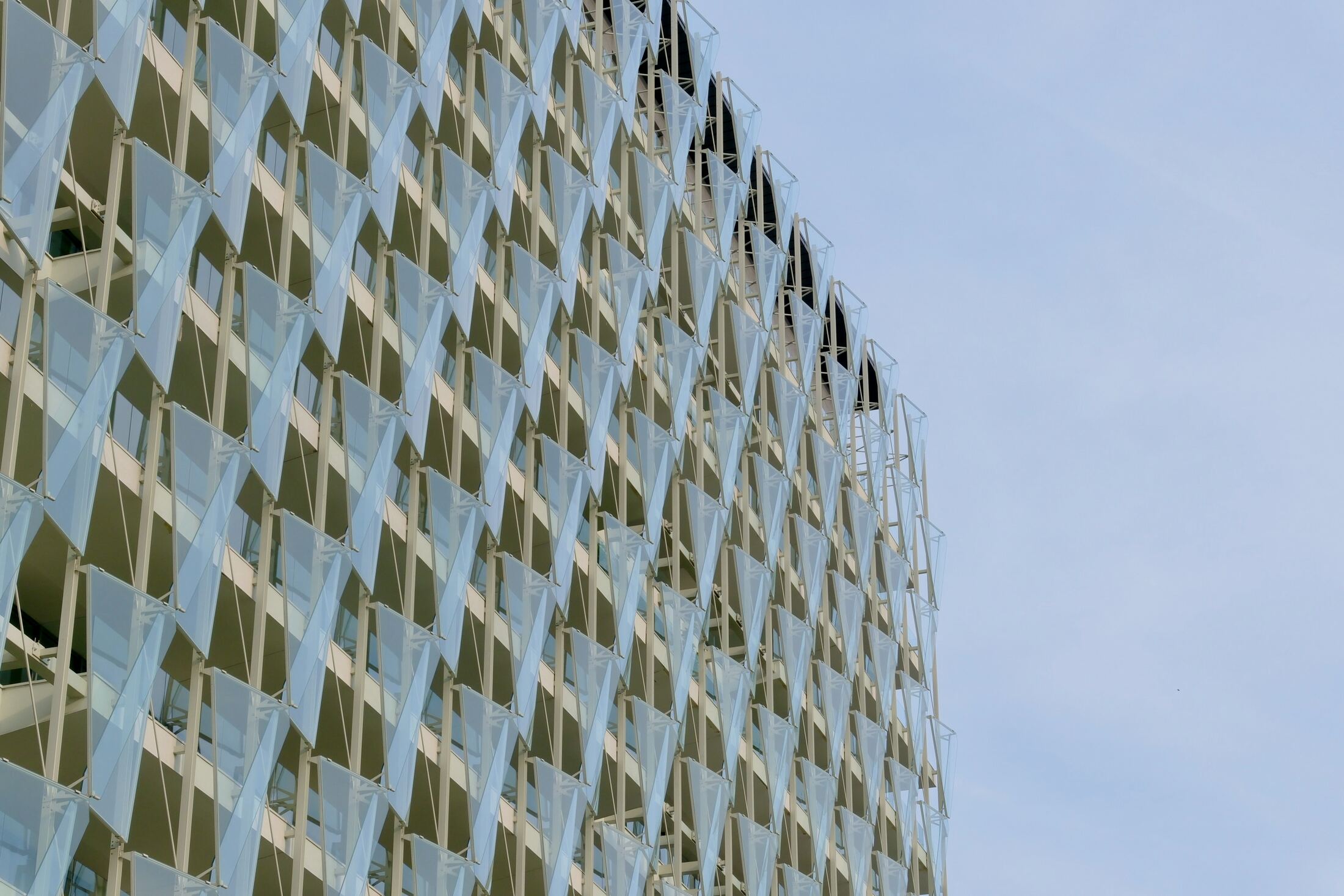 Facade detail of angled glass and metal shading fins