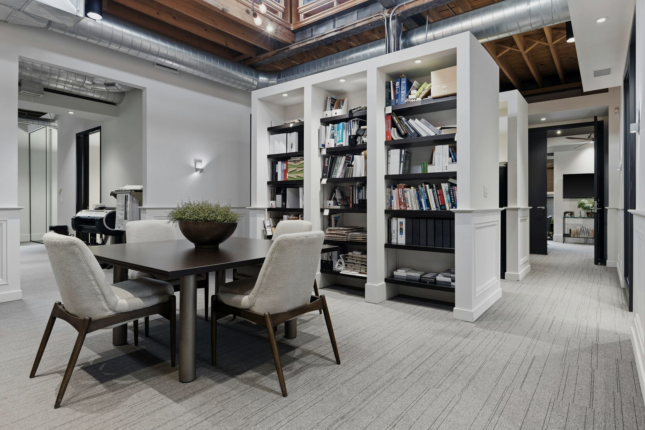 Office interior with meeting table and open shelving