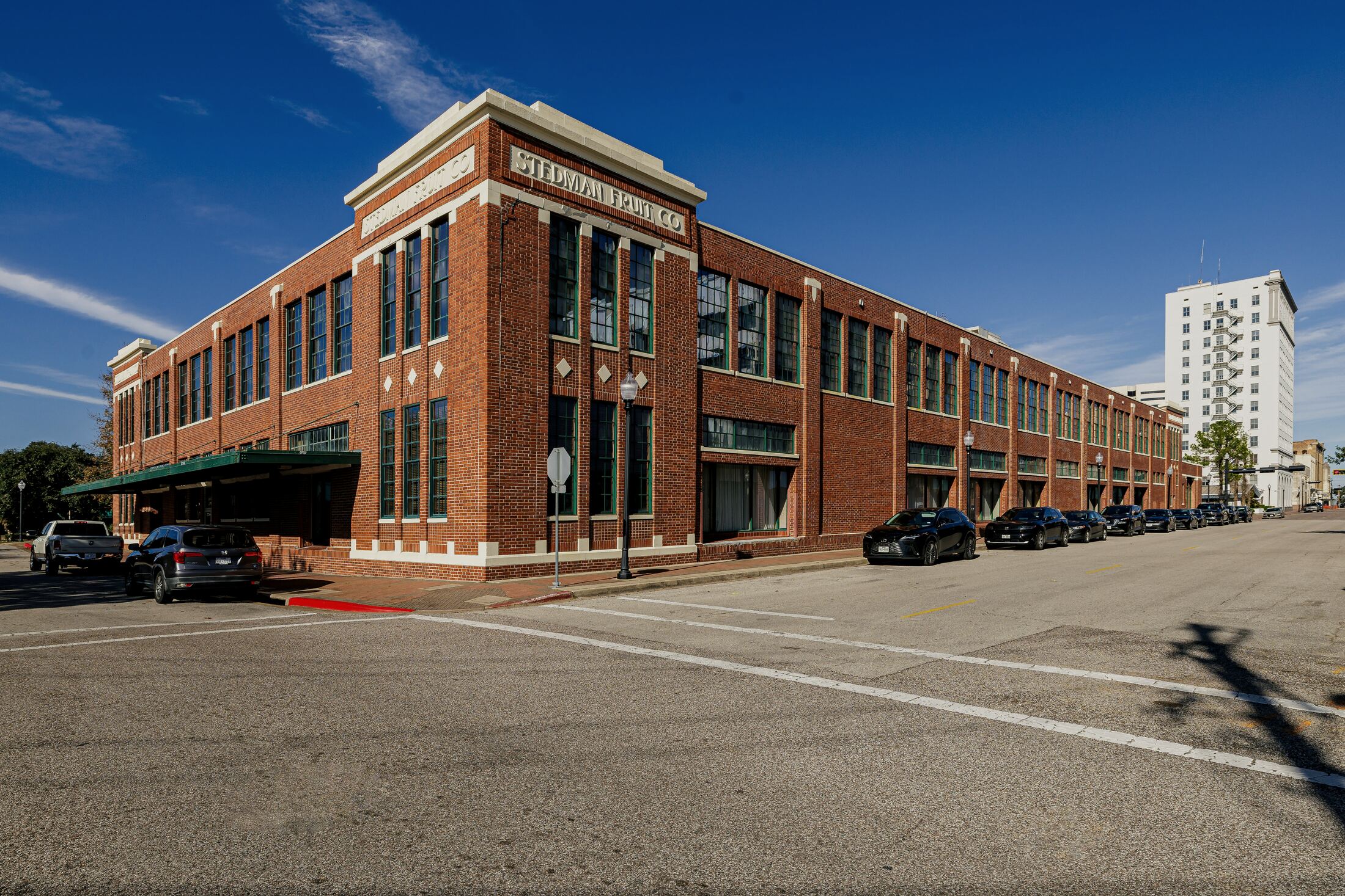 Red brick corner building photographed as a street elevation