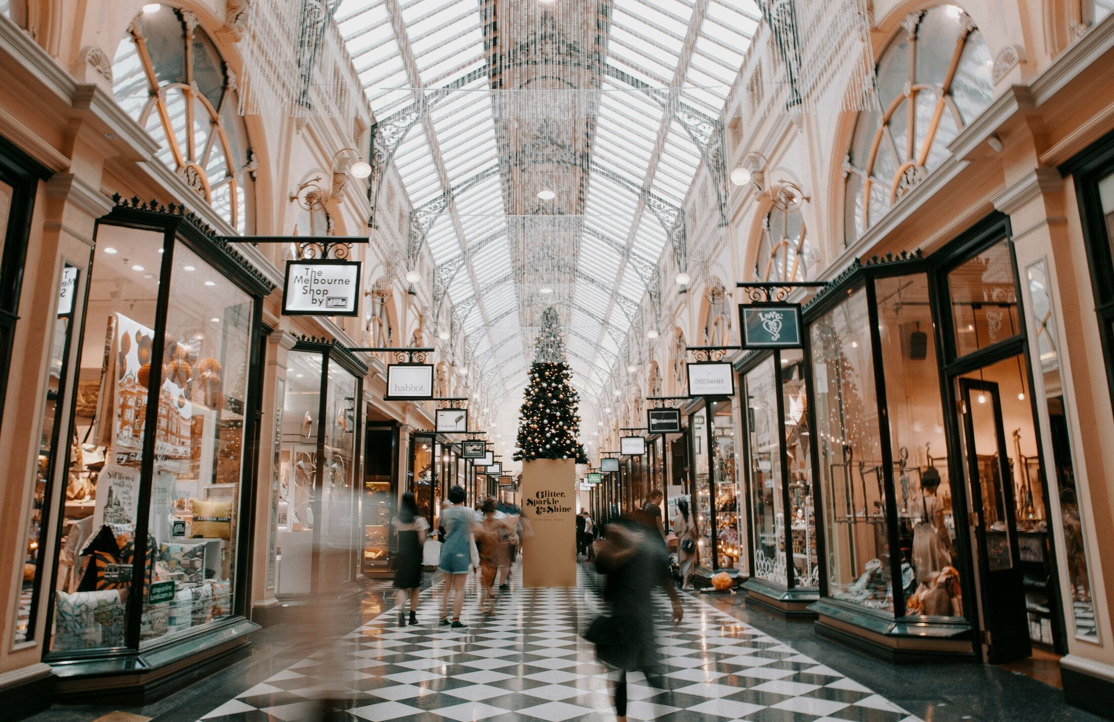 Historic retail arcade interior under a glazed roof